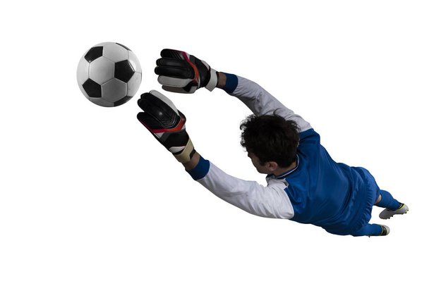 Bramkarz łapie piłkę na stadionie podczas meczu piłki nożnej. Izolowane na białym tle - Zdjęcie, obraz