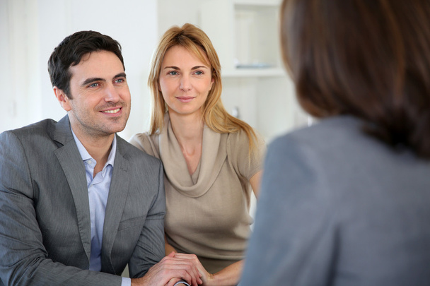 Cheerful couple receiving good news from advisor - Photo, image