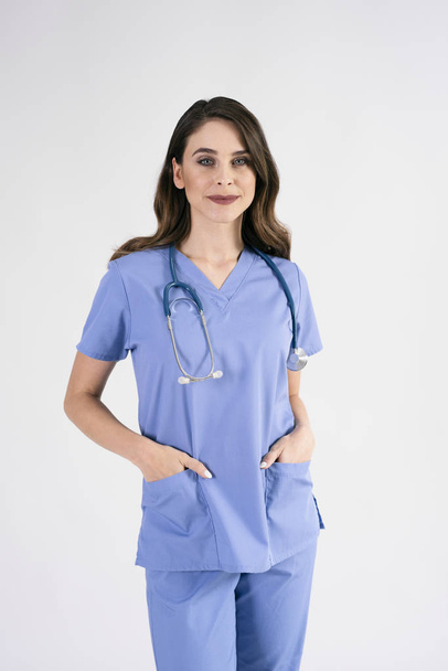Portrait of smiling nurse with stethoscope in studio shot  - Foto, Imagem
