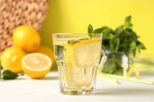 agua con limón en un fondo de color - Foto, Imagen