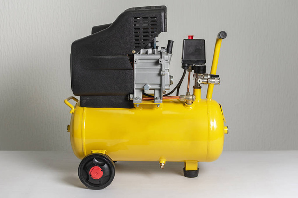 Yellow Piston Air Compressor. Compressing and Supplying Air Machine. - Photo, Image