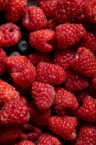 close up view of delicious ripe mixed raspberries and blueberries  - Zdjęcie, obraz