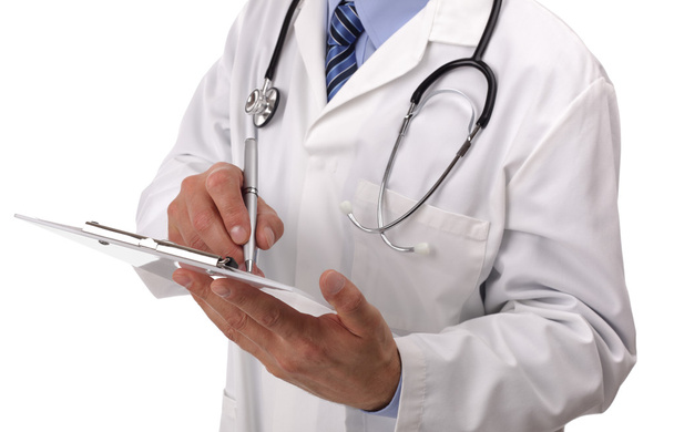 Doctor writing on medical chart - Zdjęcie, obraz