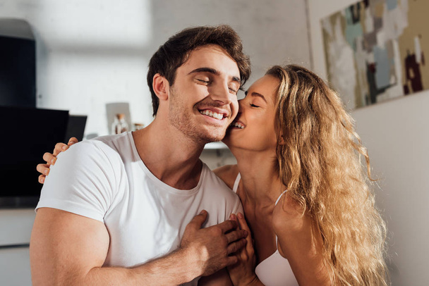 happy sexy couple embracing and smiling at home - Fotoğraf, Görsel