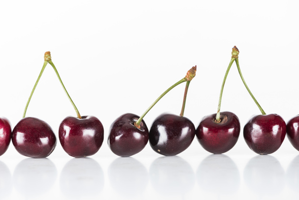 red, fresh, whole and sweet cherries on white background with copy space  - Photo, Image