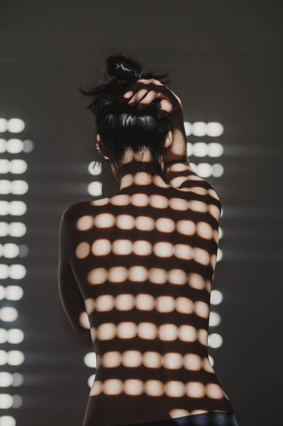  naked woman ,back view . sun is coming through the window. Indoors lifestyle - Photo, image