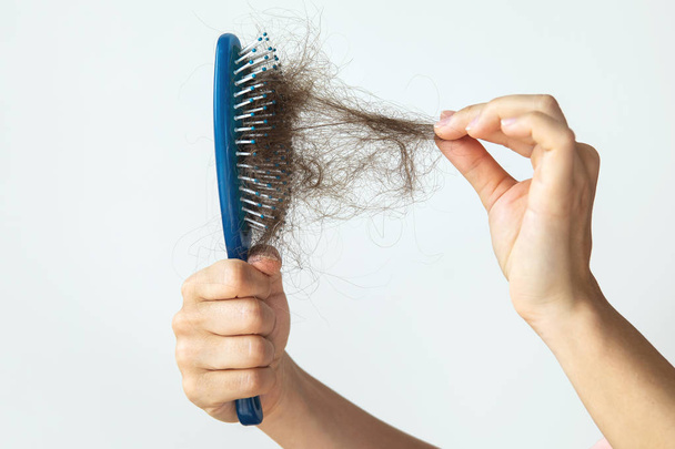 Hairbrush with a lot of female hair - 写真・画像