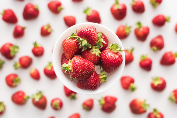 top view of sweet  and red strawberries on white bowl  - 写真・画像