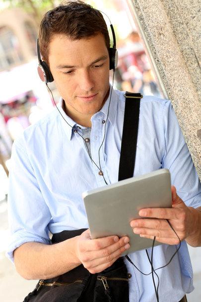 Casual man in town using digital tablet - Photo, Image
