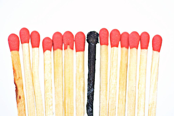 A burned and many intact matches as a symbol of the burn out syndrome - Photo, Image