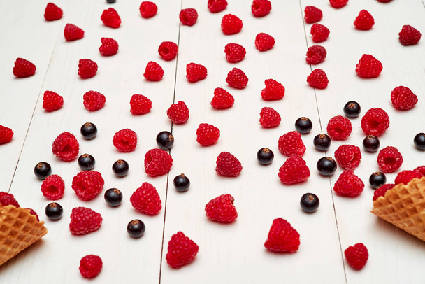 Ripe sweet raspberries and black currant in ice cream waffle con - Fotó, kép