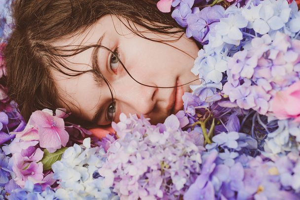 Spring woman with hydrangea flowers. Makeup cosmetics and skincare. Summer beauty. Fashion portrait of woman. Healthy hair and skin. girl with summer makeup. Hot day - Photo, Image