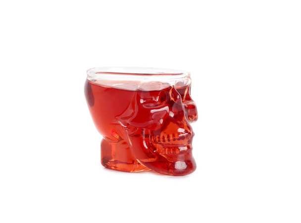 Wine glass in shape of a skull with red wine on a white background - Fotó, kép