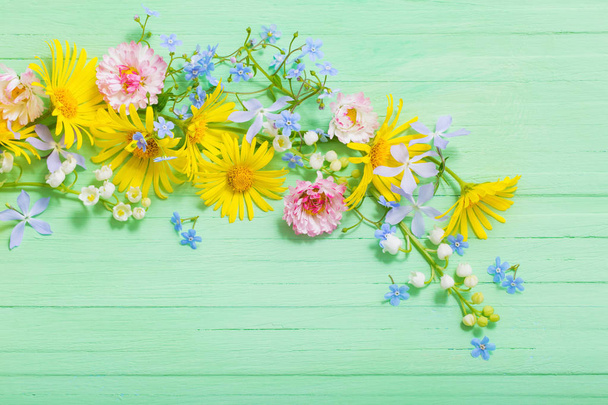 frame of beautiful flowers on green wooden background - Valokuva, kuva