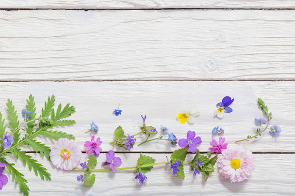 beautiful flowers on wooden background - Фото, зображення