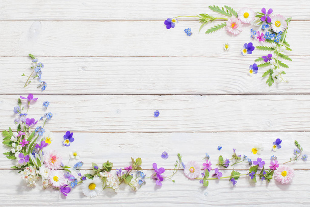 beautiful flowers on wooden background - Фото, изображение