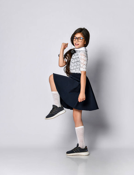 Girl cute schoolgirl in uniform - Фото, изображение