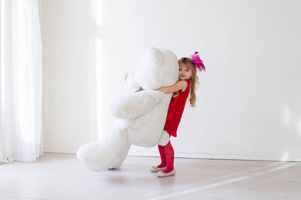 Beautiful girl with soft toy big bear - Zdjęcie, obraz