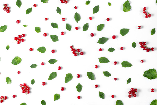 Fruit pattern made of fresh berries and green leaves on white background. Concept of healthy food. Flat lay, top view, copy space - Фото, изображение