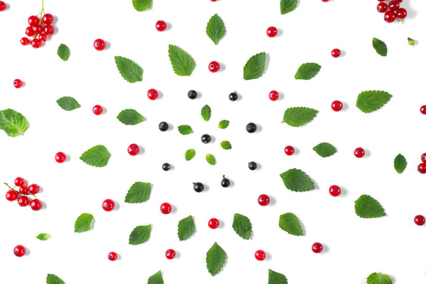 Fruit pattern made of fresh berries and green leaves on white background. Concept of healthy food. Flat lay, top view, copy space - Valokuva, kuva