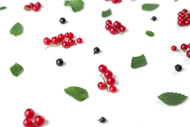 Fruit pattern made of fresh berries and green leaves on white background. Concept of healthy food. Flat lay, top view, copy space - Фото, зображення