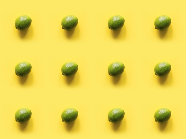 Seamleas limes pattern on punchy yellow background. Creative food concept. Flat lay. Top view. - Fotó, kép