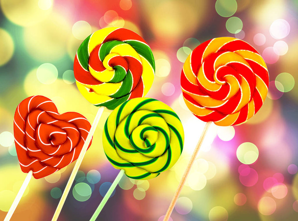 The close  up of colorful, handmade swirl lollipop on colored ba - Photo, Image