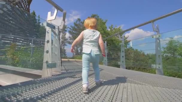 Beautiful little girl is spending the high tower - Materiał filmowy, wideo