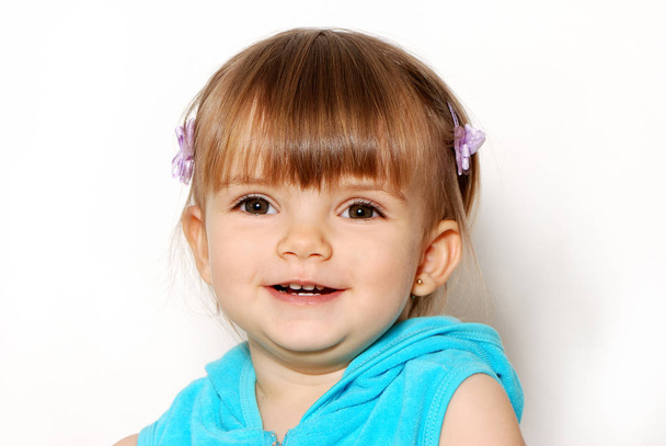 Portrait of little cute girl in blue coat on white background - Фото, зображення
