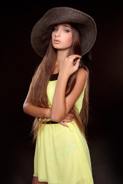 Fashion portrait of beautiful woman posing in hat isolated on bl - Photo, Image