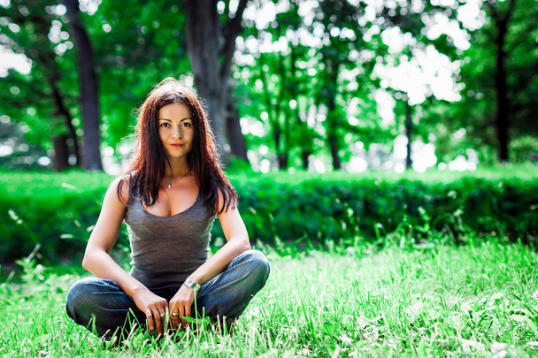 Young girl doing yoga in the park - Fotoğraf, Görsel