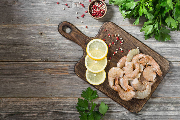 Tiger prawns on a wooden Board. Gray background. Seafood - Photo, Image
