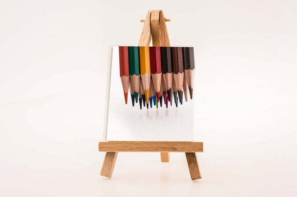 Color pencils image on notepaper on a painting tripod - Photo, Image