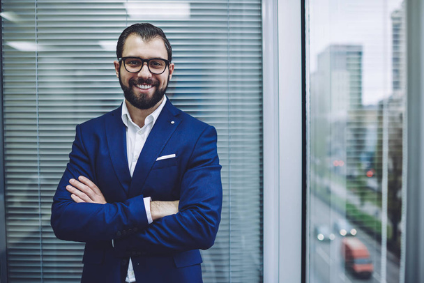 Confident cheerful male leader in stylish suit looking at camera and smiling during working time in office company, portrait of happy director in optical spectacles for provide eyes protection - Fotografie, Obrázek