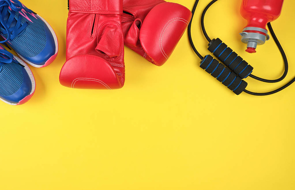 pair of red boxing gloves and blue sneakers - Photo, Image