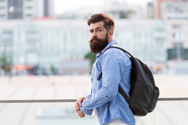 Backpack for travelling and city life. Hipster wearing backpack in casual style on urban outdoor. Bearded man travelling with backpack on summer vacation. Taking backpack in backpacking trip - Φωτογραφία, εικόνα