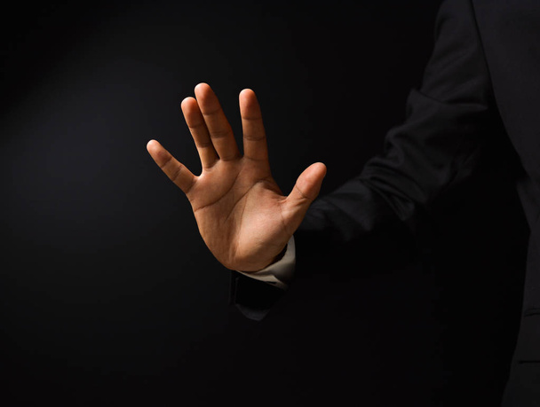 Businessman's hand on black background - Foto, immagini