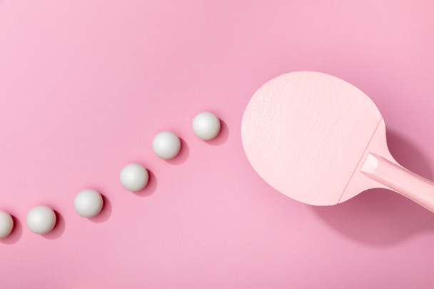 top view of white table tennis balls and racket on pink background - 写真・画像