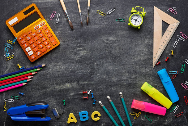 Supplies for school on blackboard background - Photo, image
