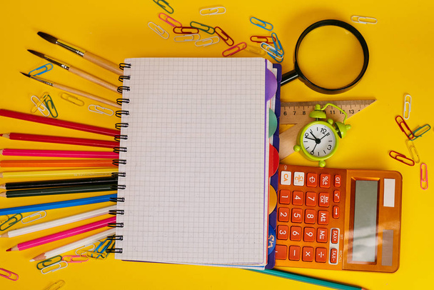 Education concept. Stationery for school on yellow background - Foto, afbeelding