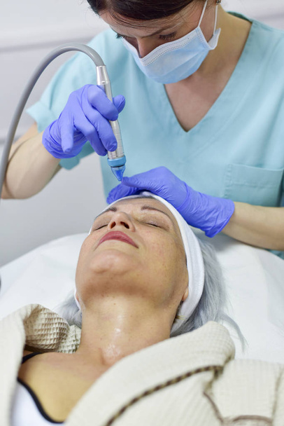 Woman receiving oxygen facial treatment - Photo, Image
