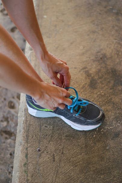 woman tying sneakers before training - Photo, image
