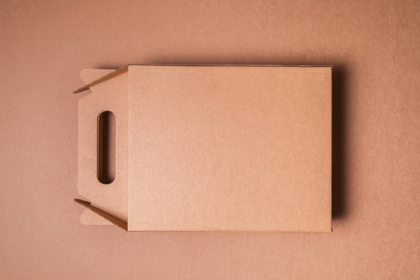 Brown craft cardboard box with handle - Fotoğraf, Görsel