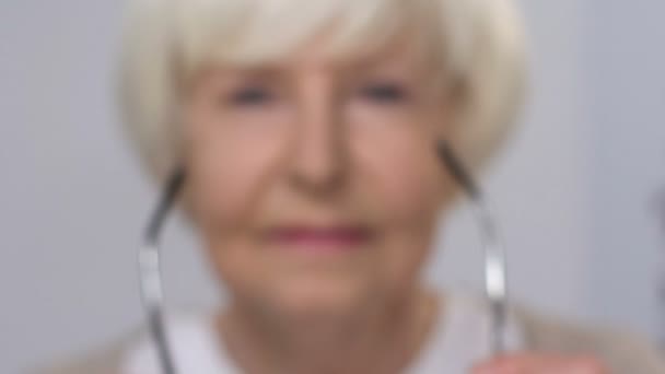 Elderly lady wearing eye glasses cheerfully smiling at camera, vision care - Footage, Video