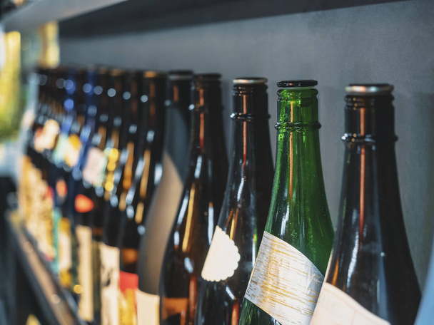 Sake bottles in row Japanese Alcohol drink Bar background - Photo, Image