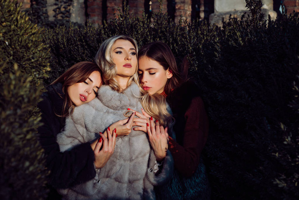 Attraction and magnetism. Warm clothes. Fashion outfit. Fashion women fur coats. Dreamy and mysterious. Sensual girls fur clothes cuddling nature background. Girls fashion models wear furry clothes - Fotó, kép