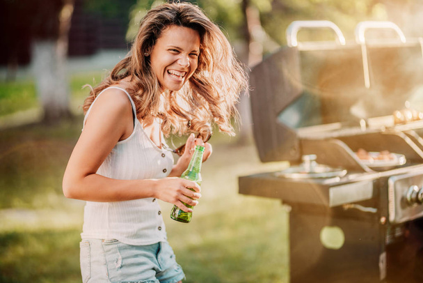 Portrait of laughing blonde girl having a great time at barbecue grill party  - Foto, Bild