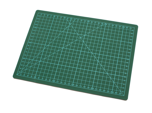 green cutting mat on a white background - Foto, afbeelding
