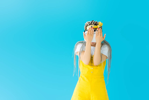 girl with dreadlocks in Virtual reality headset isolated on turquoise with copy space - Foto, immagini