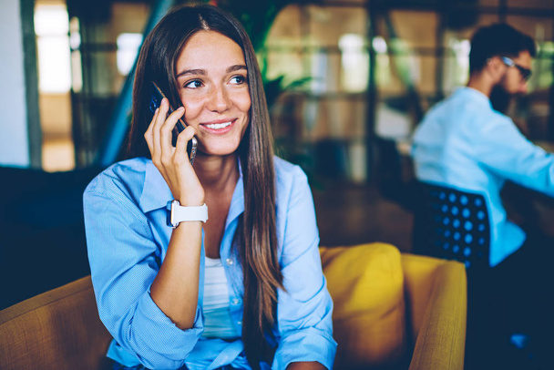 Smiling hipster girl casual dressed have smartphone conversation received happy news from work, positive caucasian woman making cellular call via application using wireless connection indoors - Foto, Bild